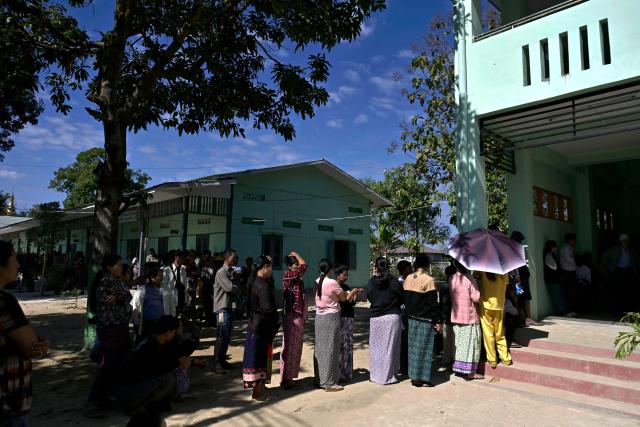 People line up to vote at a polling station during the first phase of Myanmar's general election in Naypyidaw on December 28, 2025. (Photo by Sai Aung MAIN / AFP)