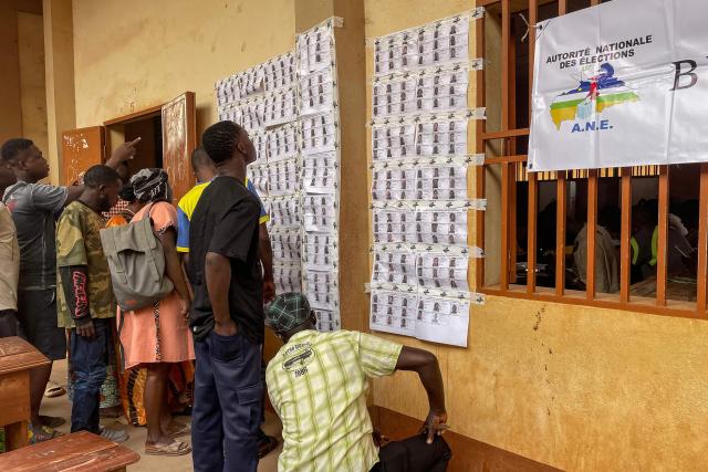 Voters check the voters' roll at a polling station in Bangui on December 28, 2025 during Central African Republic's presidential election. (Photo by Annela NIAMOLO / AFP)