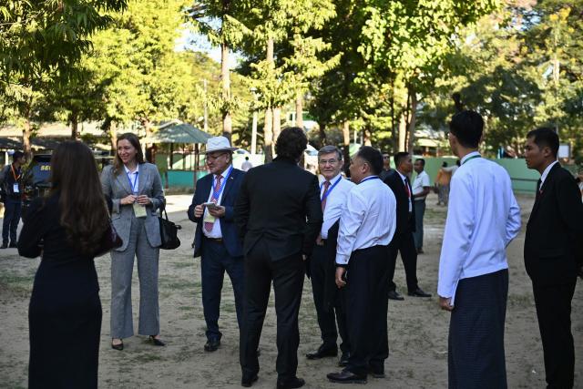 International observers arrive at a polling station in the first phase of Myanmar’s general election in Naypyidaw on December 28, 2025. (Photo by Sai Aung MAIN / AFP)