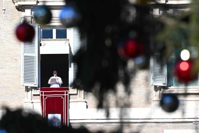 Pope Leo XIV delivers his speech to the crowd from the window of the apostolic palace overlooking St. Peter's square during the Angelus prayer in The Vatican on December 28, 2025. (Photo by Andreas SOLARO / AFP)