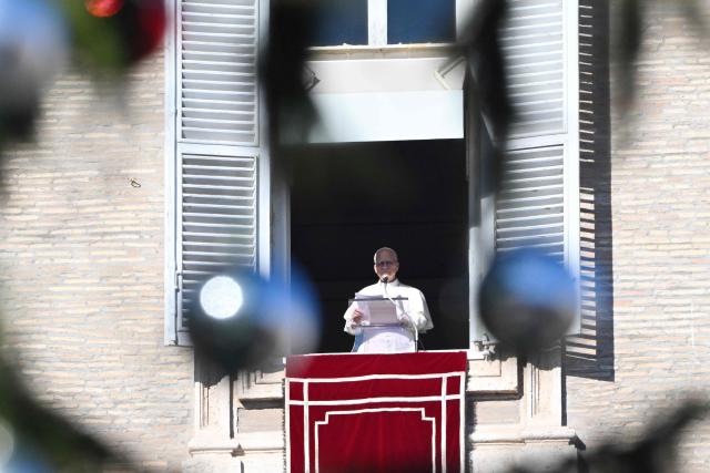 Pope Leo XIV delivers his speech to the crowd from the window of the apostolic palace overlooking St. Peter's square during the Angelus prayer in The Vatican on December 28, 2025. (Photo by Andreas SOLARO / AFP)