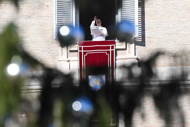 Pope Leo XIV blesses the crowd from the window of the apostolic palace overlooking St. Peter's square during the Angelus prayer in The Vatican on December 28, 2025. (Photo by Andreas SOLARO / AFP)