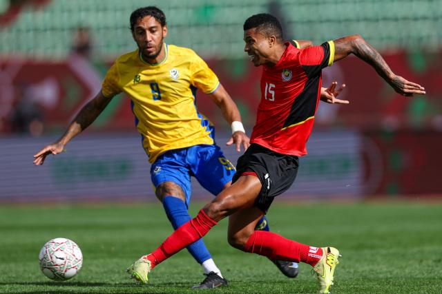 Gabon's forward #09 Pierre-Emerick Aubameyang and 15 Mozambique's defender #15 Reinildo Mandava vie during the Africa Cup of Nations (CAN) Group F football match between Gabon and Mozambique at Grand Stadium in Agadir on December 28, 2025. (Photo by FRANCK FIFE / AFP)