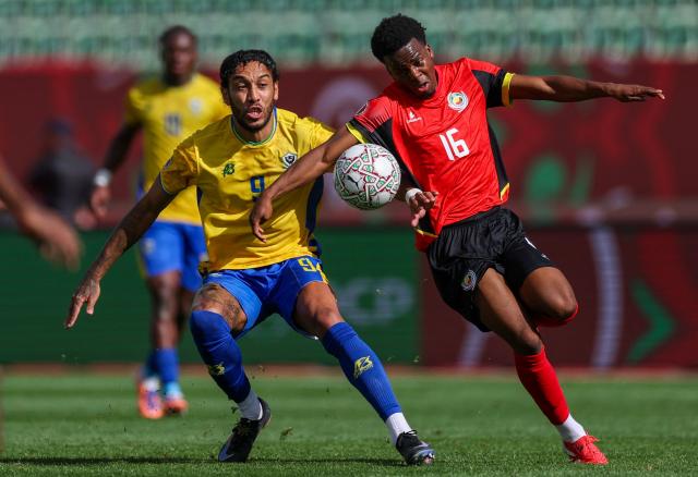 Gabon forward #09 Pierre-Emerick Aubameyang and Mozambique's midfielder #16 Alfonso Amade vie during the Africa Cup of Nations (CAN) Group F football match between Gabon and Mozambique at Grand Stadium in Agadir on December 28, 2025. (Photo by FRANCK FIFE / AFP)