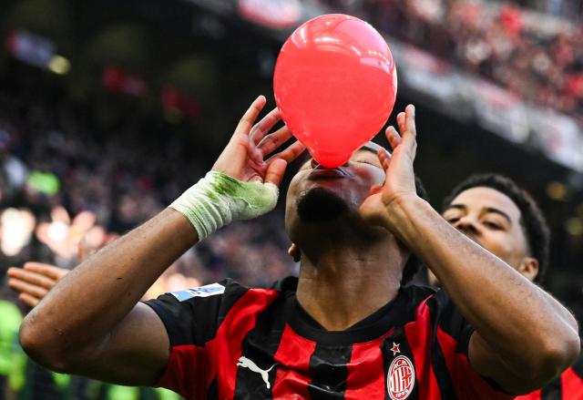 AC Milan's French forward #18 Christopher Nkunku celebrates after scoring his team second goal during the Italian Serie A football match between AC Milan and Hellas Verona at the San Siro stadium in Milan, northern Italy, on December 28, 2025. (Photo by Piero CRUCIATTI / AFP)
