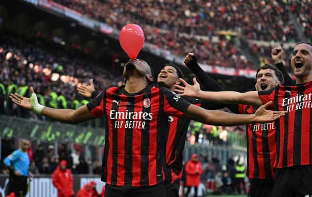 AC Milan's French forward #18 Christopher Nkunku  (L) celebrates after scoring his team second goal during the Italian Serie A football match between AC Milan and Hellas Verona at the San Siro stadium in Milan, northern Italy, on December 28, 2025. (Photo by Piero CRUCIATTI / AFP)