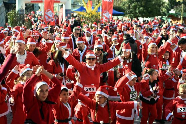 Participants dressed as Santa Claus take part in the annual Christmas city race in Skopje, on December 28, 2025. (Photo by Robert ATANASOVSKI / AFP)
