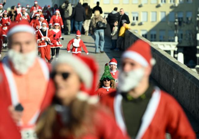 Participants dressed as Santa Claus take part in the annual Christmas city race in Skopje, on December 28, 2025. (Photo by Robert ATANASOVSKI / AFP)