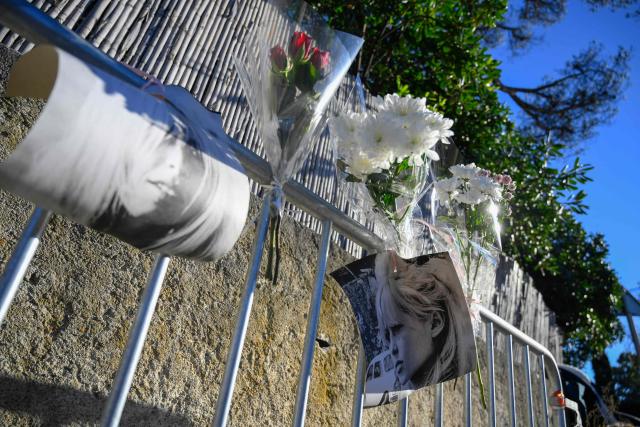 Portrais of late French actress Brigitte Bardot and flowers are displayed on barriers at the entrance of "La Madrague" house, property of late Brigitte Bardot in Saint-Tropez, southeastern France on December 28, 2025. French film legend Brigitte Bardot died at 91 AFP learnt from Bardot foundation on December 28, 2025. (Photo by Frederic DIDES / AFP)