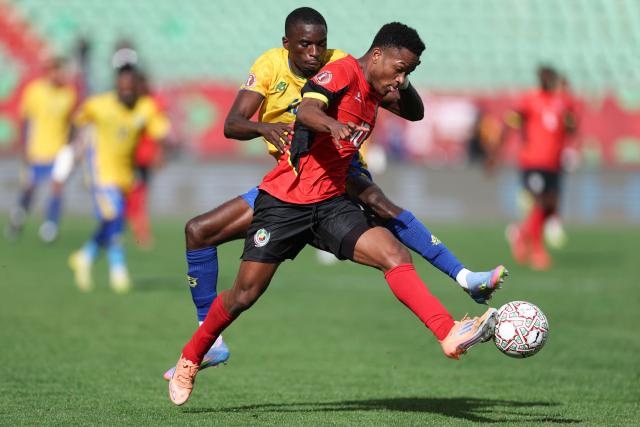 Gabon's defender #13 Mick Kila Omfia and Mozambique's midfielder #10 Geny Catamo vie during the Africa Cup of Nations (CAN) Group F football match between Gabon and Mozambique at Grand Stadium in Agadir on December 28, 2025. (Photo by FRANCK FIFE / AFP)