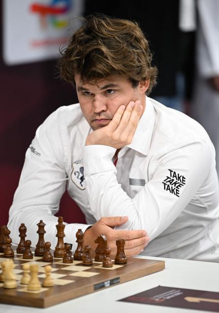 World champion and highest rancked chess player Norway's Magnus Carlsen looks on during the 11th round of the FIDE World Rapid and Blitz Championships 2025 at the Sports and Events Complex, at Qatar University in Doha on December 28, 2025 (Photo by Mahmud HAMS / AFP)