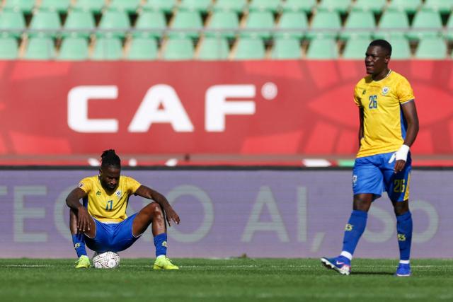 Gabon's midfielder #17 Andre Poko and Gabon's defender #26 Jonathan Do Marcolino react after the Africa Cup of Nations (CAN) Group F football match between Gabon and Mozambique at Grand Stadium in Agadir on December 28, 2025. (Photo by FRANCK FIFE / AFP)