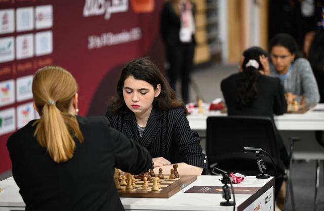 Russia's Aleksandra Goriachkina (2nd L) plays during the 11th round of the FIDE World Rapid and Blitz Championships 2025 at the Sports and Events Complex, at Qatar University in Doha on December 28, 2025. (Photo by Mahmud HAMS / AFP)