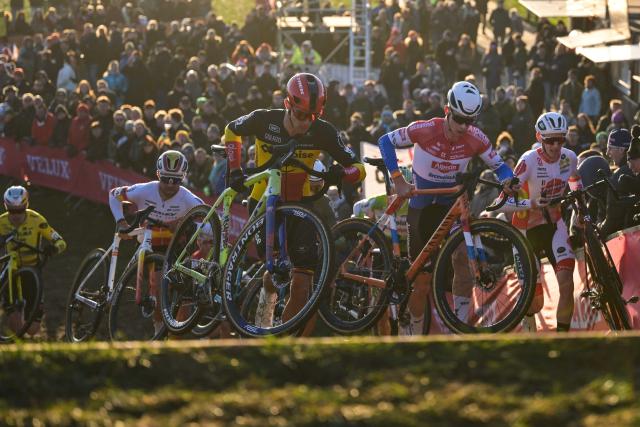Baloise Glowi Lions Team's Belgian rider Thibau Nys (C) competes in the men's elite race of the cyclo-cross World Cup, stage 8 out of 12 of the UCI World Cup competition, in Dendermonde on December 28, 2025. (Photo by DAVID PINTENS / BELGA / AFP)