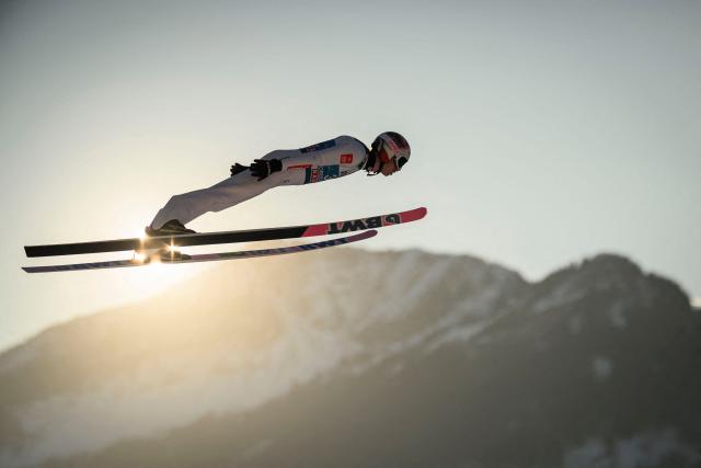 Poland's Pawel Wasek soars through the air during the training for the Men's Individual Large Hill HS137 event of the FIS Ski Jumping World Cup, the first leg of the Four Hills Tournament, in Oberstdorf, southern Germany on December 28, 2025. (Photo by Philipp Guelland / AFP)