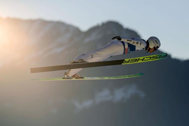 Japan's Tomofumi Naito soars through the air during the training for the Men's Individual Large Hill HS137 event of the FIS Ski Jumping World Cup, the first leg of the Four Hills Tournament, in Oberstdorf, southern Germany on December 28, 2025. (Photo by Philipp Guelland / AFP)