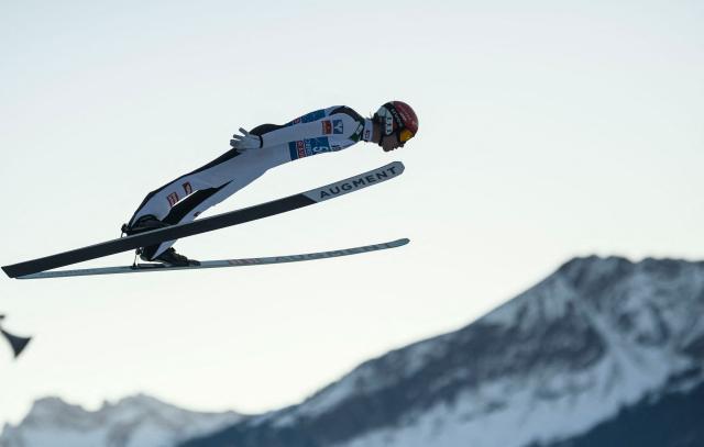 Austria's Manuel Fettner soars through the air during the training for the Men's Individual Large Hill HS137 event of the FIS Ski Jumping World Cup, the first leg of the Four Hills Tournament, in Oberstdorf, southern Germany on December 28, 2025. (Photo by Philipp Guelland / AFP)