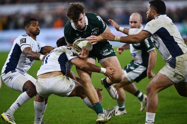 ackled Pau's French centre Fabien Brau-Boirie (C) is tackled during the French Top14 rugby union match between Section Paloise Bearn Pyrenees (Pau) and Montpellier Herault Rugby at Stade du Hameau in Pau, south-western France on December 28, 2025. (Photo by Gaizka IROZ / AFP)