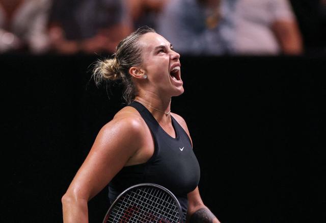 Belarus’ Aryna Sabalenka reacts during her Battle of the Sexes exhibition tennis match against Australia's Nick Kyrgios in Dubai on December 28, 2025. (Photo by Amr Alfiky / POOL / AFP)