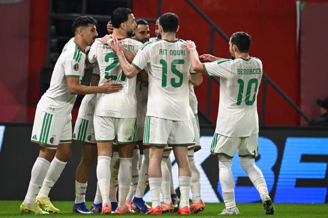 Algeria's forward #7 Riyad Mahrez (3rd L) celebrates his team's first goal with his teammates during the Africa Cup of Nations (CAN) Group E football match between Algeria and Burkino Faso at Moulay Hassan Stadium in Rabat on December 28, 2025. (Photo by Paul ELLIS / AFP)