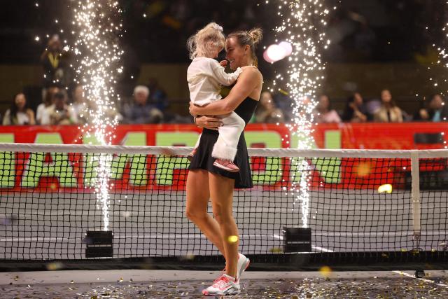 Belarus' Aryna Sabalenka celebrates with her goddaughter Nicole after her Battle of the Sexes exhibition tennis match against Australia's Nick Kyrgios in Dubai on December 28, 2025. Kyrgios won the match. (Photo by Amr Alfiky / POOL / AFP)