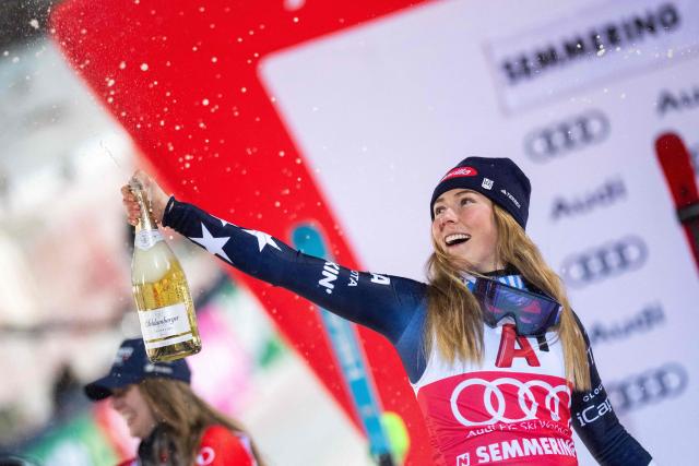 Winner USA's Mikaela Shiffrin celebrates on the podium with sparkling wine after the Women's Slalom race of the FIS Alpine Ski World Cup in Semmering, Austria on December 28, 2025. (Photo by GEORG HOCHMUTH / APA / AFP) / Austria OUT