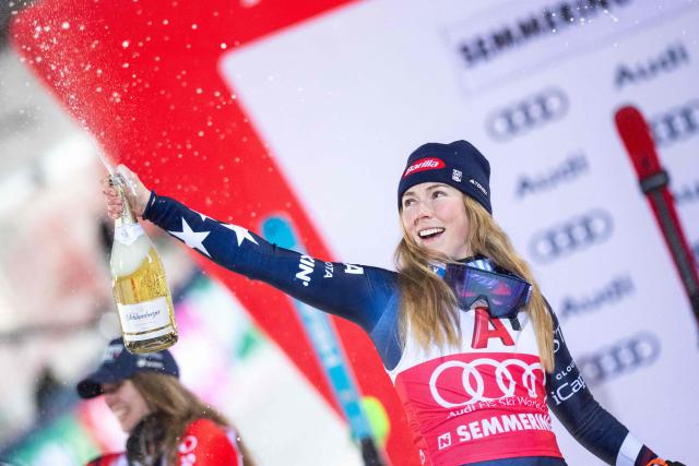 Winner USA's Mikaela Shiffrin celebrates on the podium with sparkling wine after the Women's Slalom race of the FIS Alpine Ski World Cup in Semmering, Austria on December 28, 2025. (Photo by GEORG HOCHMUTH / APA / AFP) / Austria OUT