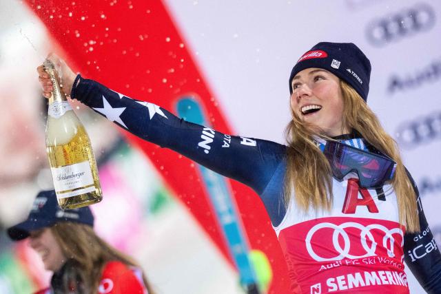 TOPSHOT - Winner USA's Mikaela Shiffrin celebrates on the podium with sparkling wine after the Women's Slalom race of the FIS Alpine Ski World Cup in Semmering, Austria on December 28, 2025. (Photo by GEORG HOCHMUTH / APA / AFP) / Austria OUT