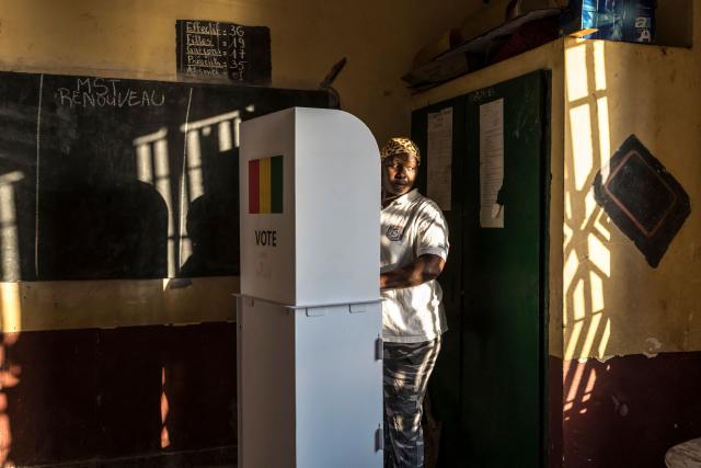 TOPSHOT - A voter marks her ballot behind a voting booth at the Federico Mayor Primary School during Guinea's presidential election, in Conakry, on December 28, 2025. (Photo by PATRICK MEINHARDT / AFP)
