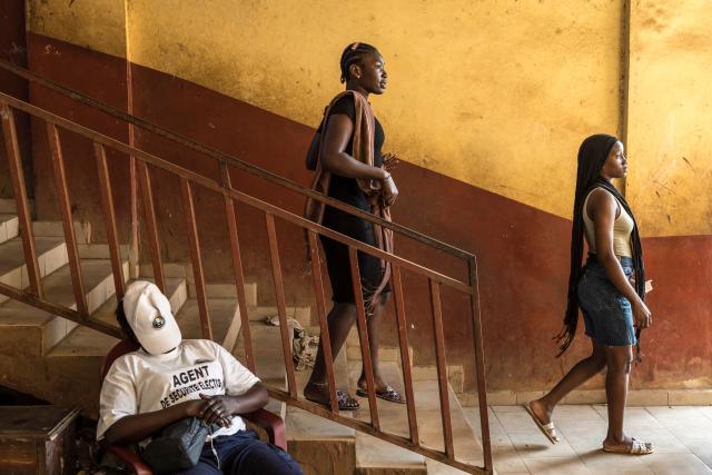 Voters leave the Federico Mayor Primary School after casting their ballots during Guinea's presidential election, in Conakry, on December 28, 2025. (Photo by PATRICK MEINHARDT / AFP)