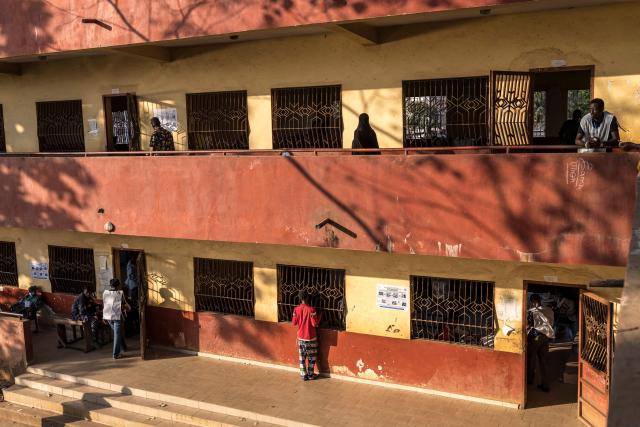 Voters walk at the Federico Mayor Primary School during Guinea's presidential election, in Conakry, on December 28, 2025. (Photo by PATRICK MEINHARDT / AFP)