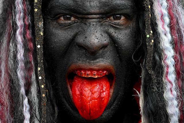 TOPSHOT - A Bolero (a main character of Holy Innocents’ Day) with his face painted black poses for a portrait during the celebration of Holy Innocents’ Day in Caucagua, Miranda state, Venezuela on December 28, 2025. (Photo by Federico PARRA / AFP)