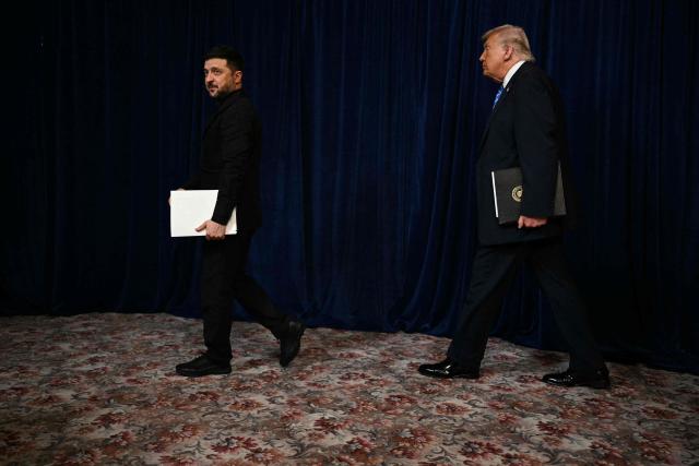 US President Donald Trump and Ukranian President Volodymyr Zelensky arrive at a press conference following talks at Trump's Mar-a-Lago residence in Palm Beach, Florida, on December 28, 2025. (Photo by Jim WATSON / AFP)