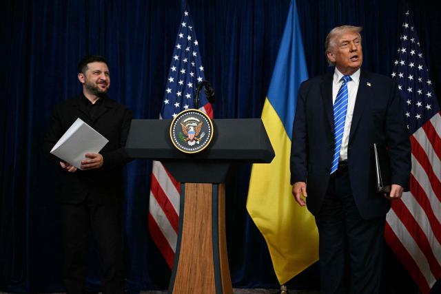 US President Donald Trump and Ukranian President Volodymyr Zelensky arrive at a press conference following talks at Trump's Mar-a-Lago residence in Palm Beach, Florida, on December 28, 2025. (Photo by Jim WATSON / AFP)