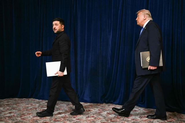 Ukranian President Volodymyr Zelensky and US President Donald Trump arrive at a press conference following talks at Trump's Mar-a-Lago residence in Palm Beach, Florida, on December 28, 2025. (Photo by Jim WATSON / AFP)