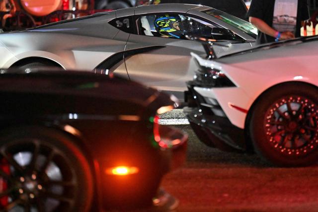 A pilot prepares himself with his car to participate in a car exhibition at La Carlota air base in Caracas on December 28, 2025. (Photo by Juan BARRETO / AFP)