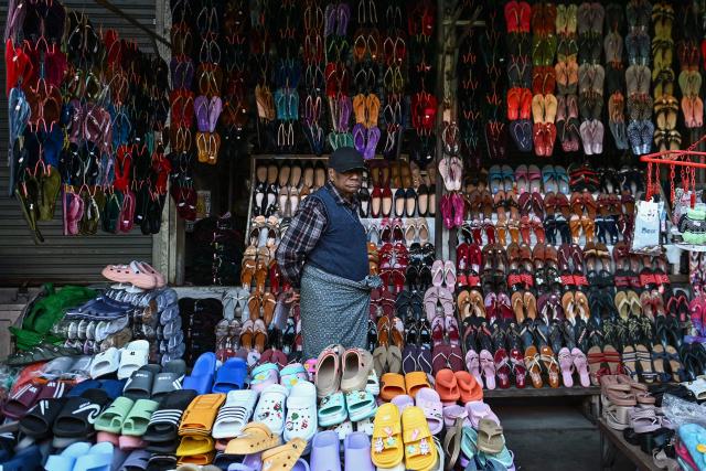 A footwear vendor waits for customers at a market in Naypyidaw on December 29, 2025, a day after the first phase of Myanmar's general election. (Photo by Sai Aung MAIN / AFP)