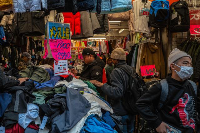 Customers browse a clothing store ahead of the new year in Tokyo's Ueno shopping district on December 29, 2025. (Photo by Philip FONG / AFP)