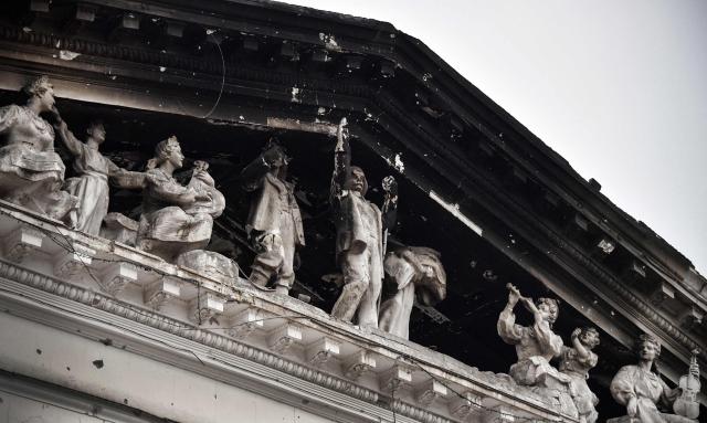 (FILES) This photograph taken on April 12, 2022 shows the facade of the partially destroyed Mariupol drama theatre, bombed last March 16, in Mariupol as Russian troops intensify a campaign to take the strategic port city. A theatre that became one of the bombed out symbols of a Russian siege of the city of Mariupol in eastern Ukraine in 2022 has reopened after a huge redevelopment, Russian authorities have announced. (Photo by Alexander NEMENOV / AFP)