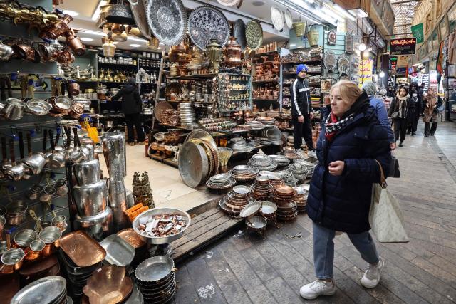 People shop at Tajrish Bazaar in the Iranian capital Tehran on December 29, 2025. (Photo by ATTA KENARE / AFP)