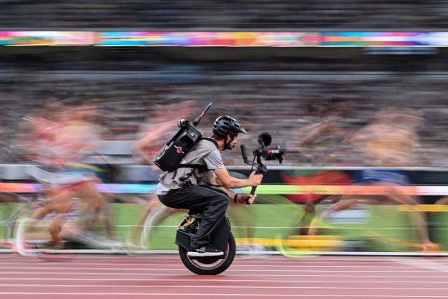 AFP PICTURES OF THE YEAR 2025

A cameraman on a unicycle films athletes in action as they compete in the men's 10000m final during the World Athletics Championships in Tokyo on September 14, 2025. (Photo by Kirill KUDRYAVTSEV / AFP) / AFP PICTURES OF THE YEAR 2025