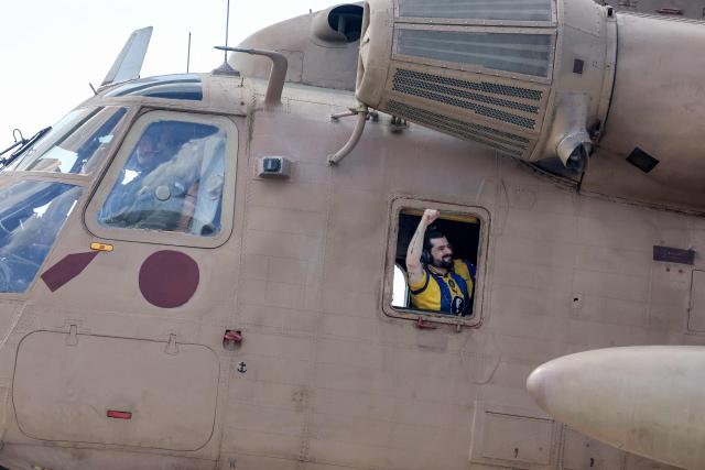 AFP PICTURES OF THE YEAR 2025

Ziv Berman, one of the released Israeli hostages formerly held captive in Gaza since the 2023 October 7 attacks by Palestinian militants, gestures from the window of an Israeli CH-53 Sea Stallion military helicopter at Sheba Tel-HaShomer Medical Centre in Ramat Gan on October 13, 2025. (Photo by Ahmad GHARABLI / AFP) / AFP PICTURES OF THE YEAR 2025