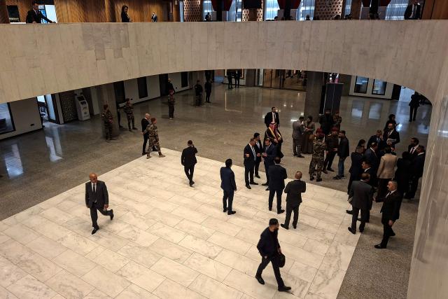 Officials stand in the lobby of Iraq’s parliament building in Baghdad as newly elected lawmakers are due to hold their first session on December 29, 2025. (Photo by AHMAD AL-RUBAYE / AFP)