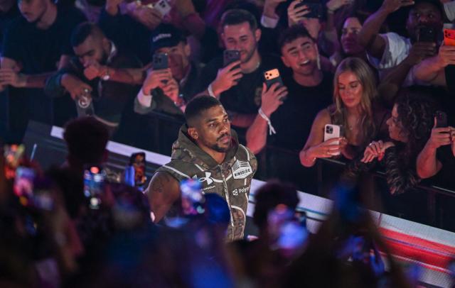 (FILES) British boxer Anthony Joshua arrives for his non-title heavyweight bout against US boxer and influencer Jake Paul at the Kaseya Center in Miami, Florida on December 19, 2025. Former world heavyweight champion Anthony Joshua was injured in a fatal highway accident that killed two people on December 29, 2025, Nigerian media reported.
Punch newspaper said the crash occurred on the Lagos-Ibadan expressway when the car he was riding in collided with a truck. (Photo by Giorgio VIERA / AFP)