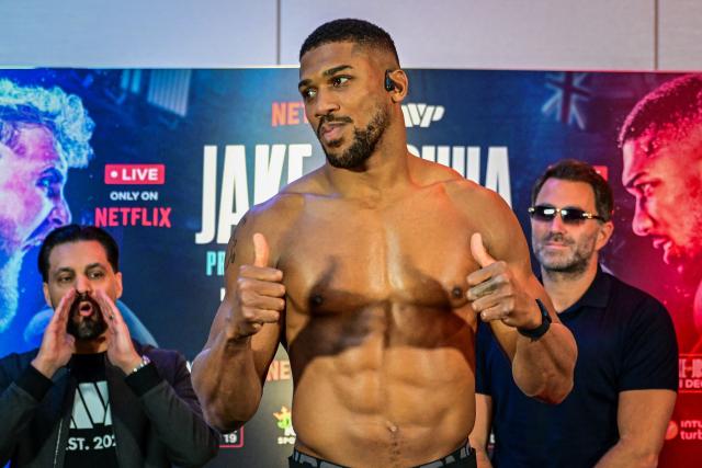 (FILES) Britain's Anthony Joshua attends the official weigh-in at the Fillmore Miami Beach on December 18, 2025, ahead of his fight against US boxer and influencer Jake Paul on December 19 non-title heavyweight bout in Miami. Former world heavyweight champion Anthony Joshua was injured in a fatal highway accident that killed two people on December 29, 2025, Nigerian media reported.
Punch newspaper said the crash occurred on the Lagos-Ibadan expressway when the car he was riding in collided with a truck. (Photo by GIORGIO VIERA / AFP)