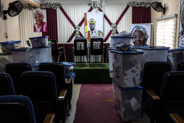 A portrait of Guinea President and presidential candidate Mamady Doumbouya is seen next to ballot boxes full of electoral materials at Kaloum’s city hall in Conakry, on December 29, 2025, the day after voting during Guinea’s presidential election. Initial results in Guinea's presidential election were due on December 29, 2025, officials said, a day after the vote in which junta chief Mamady Doumbouya is seeking to legitimise his rule.
The main opposition leaders were barred from standing and had urged a boycott of the ballot, which comes four years after Doumbouya led a coup to topple Guinea's first freely elected president. (Photo by PATRICK MEINHARDT / AFP)