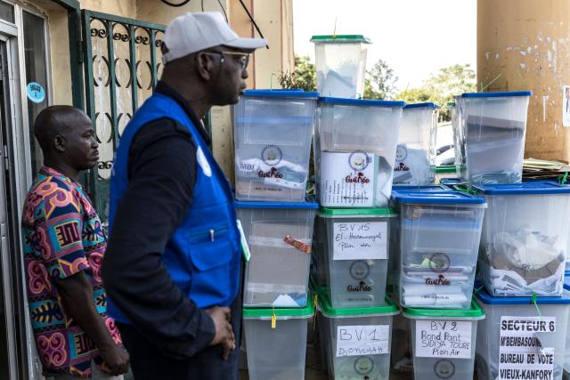 Officials of the General Directorate of Elections (DGE) stand next to ballot boxes full of electoral materials at Dixinn’s city hall in Conakry, on December 29, 2025, the day after voting during Guinea’s presidential election. Initial results in Guinea's presidential election were due on December 29, 2025, officials said, a day after the vote in which junta chief Mamady Doumbouya is seeking to legitimise his rule.
The main opposition leaders were barred from standing and had urged a boycott of the ballot, which comes four years after Doumbouya led a coup to topple Guinea's first freely elected president. (Photo by PATRICK MEINHARDT / AFP)