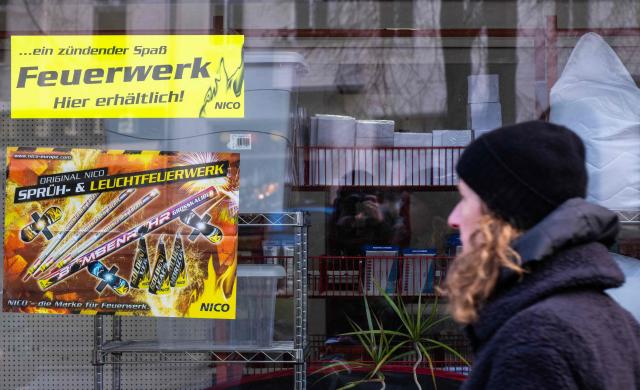 A poster in a shop window advertises fireworks in Berlin on December 29, 2025, as the sale of fireworks officially resumed in the capital. (Photo by John MACDOUGALL / AFP)