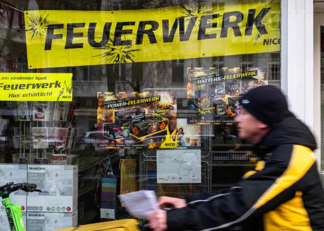 Posters and a banner in a shop window advertise fireworks in Berlin on December 29, 2025, as the sale of fireworks officially resumed in the capital. (Photo by John MACDOUGALL / AFP)