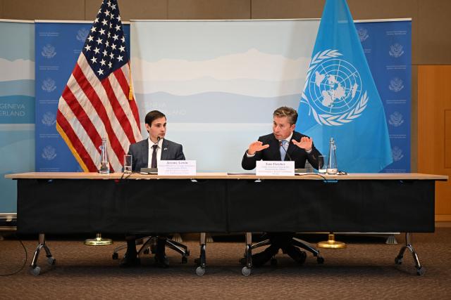 US Under Secretary of State for Foreign Assistance, Humanitarian Affairs and Religious Freedom Jeremy Lewin (L) and United Nations Under-Secretary-General for Humanitarian Affairs Tom Fletcher attend the signing ceremony of a $2 billion pledge of United States for United Nations humanitarian aid in 2026, at the US Mission in Geneva, on December 29, 2025. According to UN data, the United States remains the top humanitarian aid donor in the world, but that amount fell significantly in 2025 to $2.7 billion, down from around $11 billion in 2023 and 2024 and from over $14 billion in 2022. (Photo by Fabrice COFFRINI / AFP)
